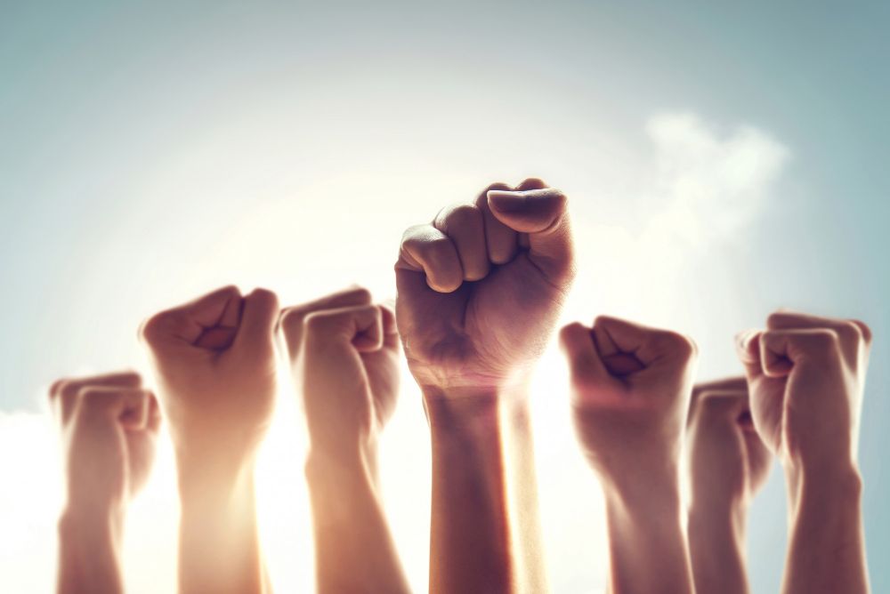 Raised hands of women signifying protest